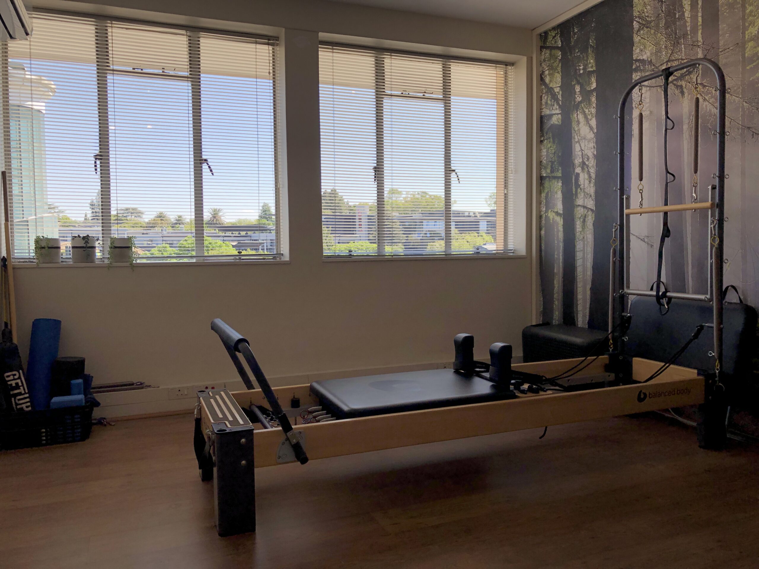 Photo of the Hyde Park Physiotherapy Pilates area showing a Pilates Reformer against bright windows.